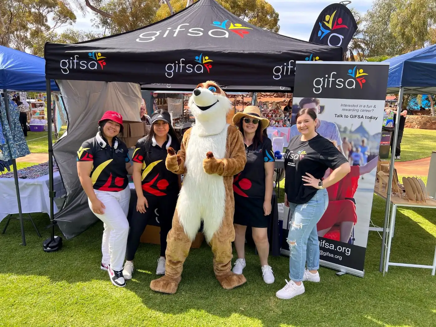 GIFSA staff and a mascot at the GIFSA stall at the Spring Festival